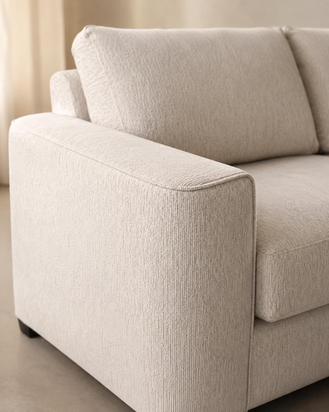 Wide arms, intricate piping, curved timber legs